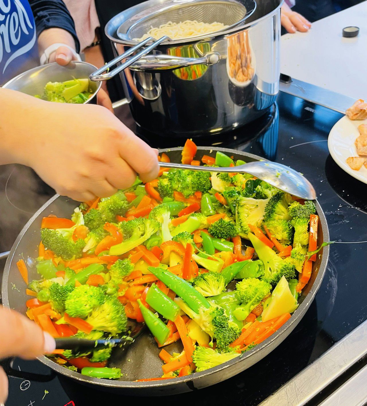 Grønsaker blir steikte i ei steikjepanne