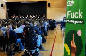 Representantar for kvart ungdomsparti sit på ei scene framfor sittande ungdom i ein gymsal