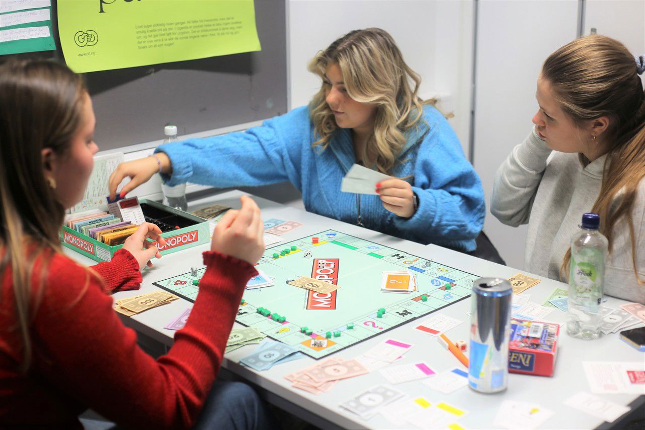 Tre jenter spelar Monopol